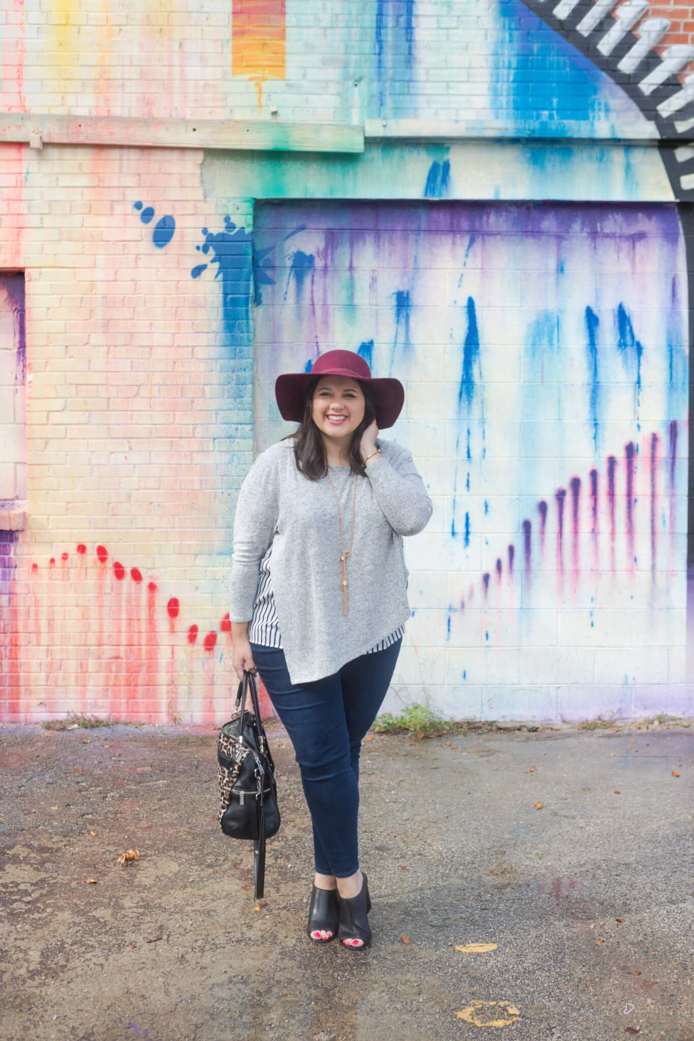 Emily Bastedo from curvy style blog, Something Gold, Something Blue is braving the heat of Houston to share this asymmetrical comfy sweater from Lane Bryant. Paired with my favorite Old Navy maroon hat and a functional leopard bag, tassel Kendra Scott necklace and Cole Haan booties, I am so ready for the fall weather. 