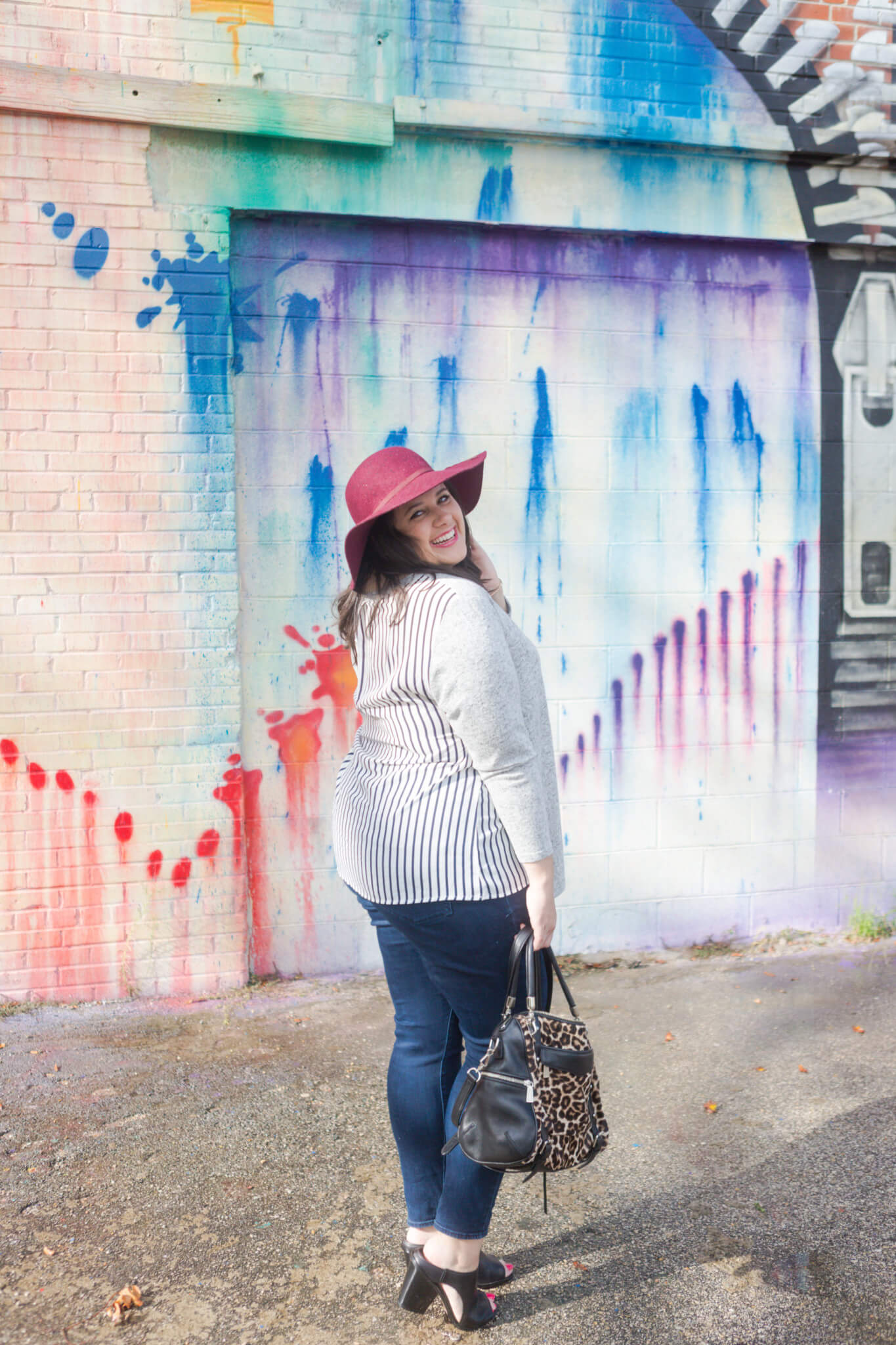 Emily Bastedo from curvy style blog, Something Gold, Something Blue is braving the heat of Houston to share this asymmetrical comfy sweater from Lane Bryant. Paired with my favorite Old Navy maroon hat and a functional leopard bag, tassel Kendra Scott necklace and Cole Haan booties, I am so ready for the fall weather. 