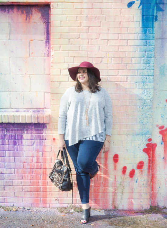 Emily Bastedo from curvy style blog, Something Gold, Something Blue is braving the heat of Houston to share this asymmetrical comfy sweater from Lane Bryant. Paired with my favorite Old Navy maroon hat and a functional leopard bag, tassel Kendra Scott necklace and Cole Haan booties, I am so ready for the fall weather.