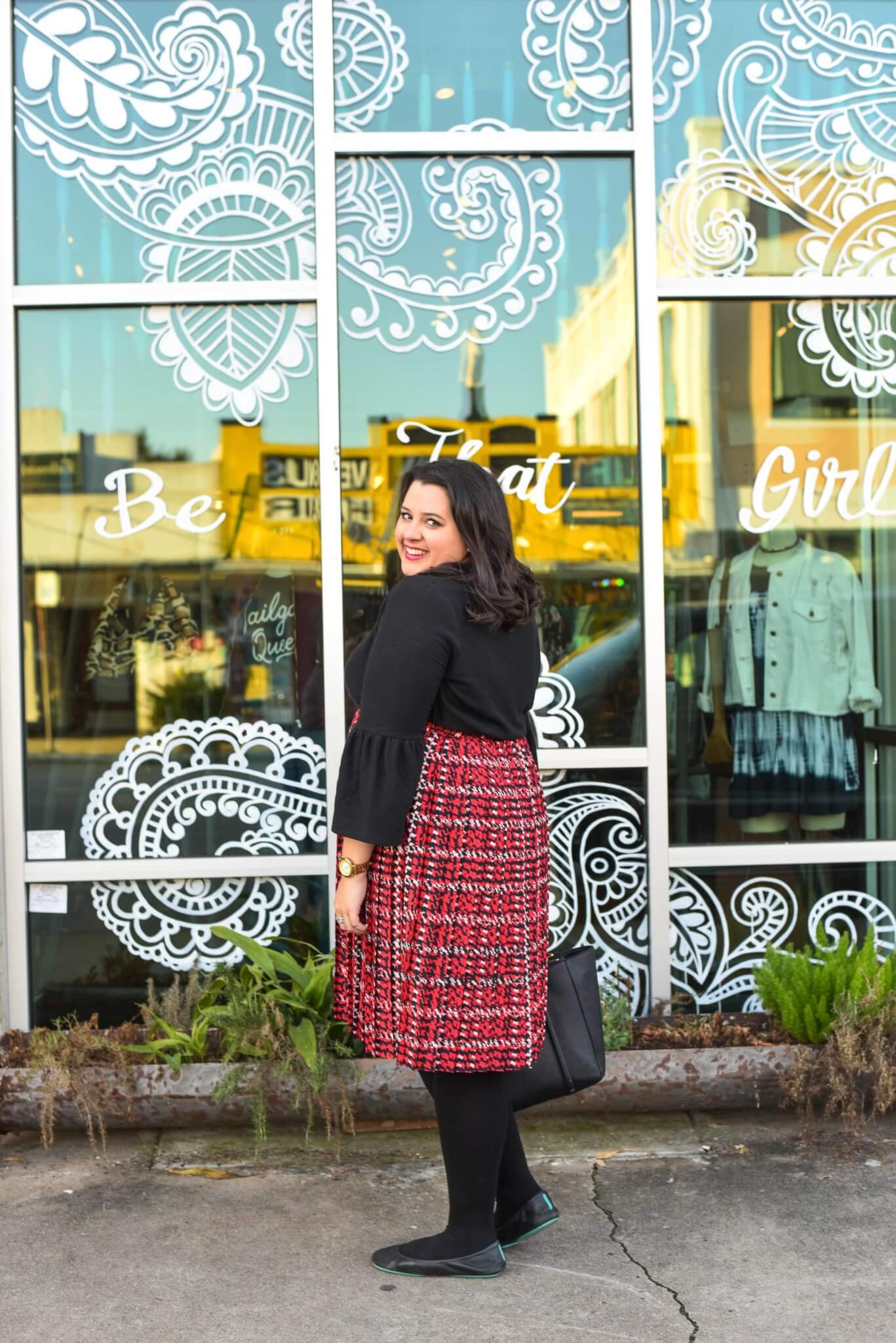 Dressing for all of the holiday season functions can be difficult epecially when you work long hours. Emily Bastedo from the curvy style blog Something Gold, Something Blue, is sharing her solution by styling a red plaid skirt and unique black sweater from Eloquii paired with gorgeous and comfortable Just My Size tights and Tieks.