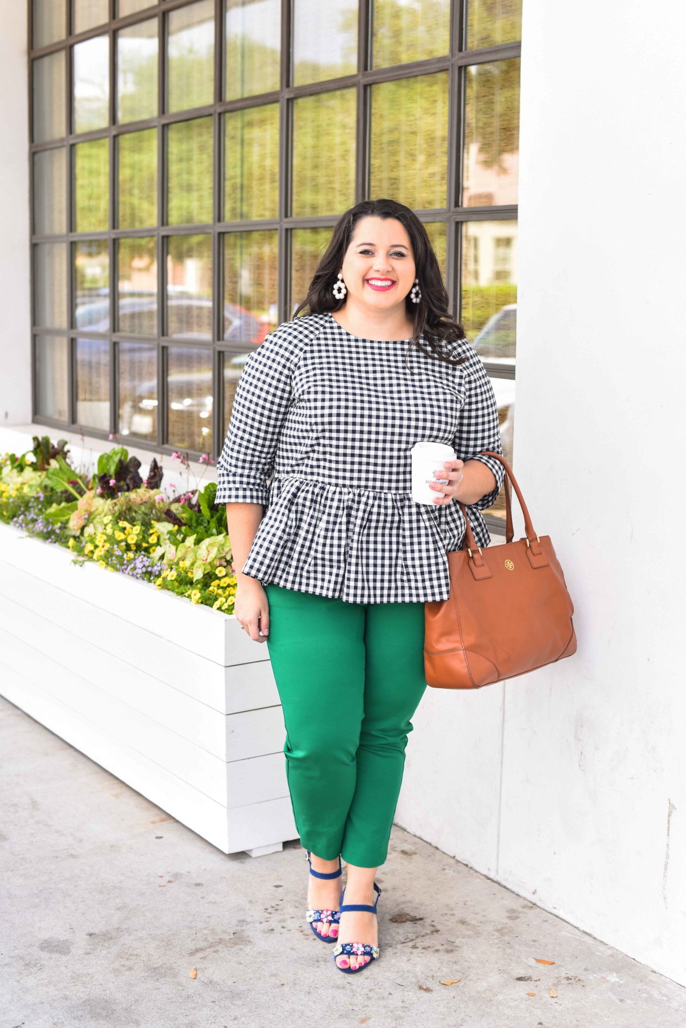 Traveling can be stressful, especially when your flight is delayed or even worse, cancelled. In today’s blog post, I’m sharing a few travel delay tips that will help you make the best of the situation. I’m also talking about wearing a quintessential preppy item, a gingham peplum top. Emily Bastedo from the curvy style blog, Something Gold, Something Blue, is sharing how she is styling this gorgeous spring top perfect for both work and happy hour. Plus size, curvy, fashion, style, travel tips. - Travel Delays by popular Houston travel blogger Something Blue, Something Gold