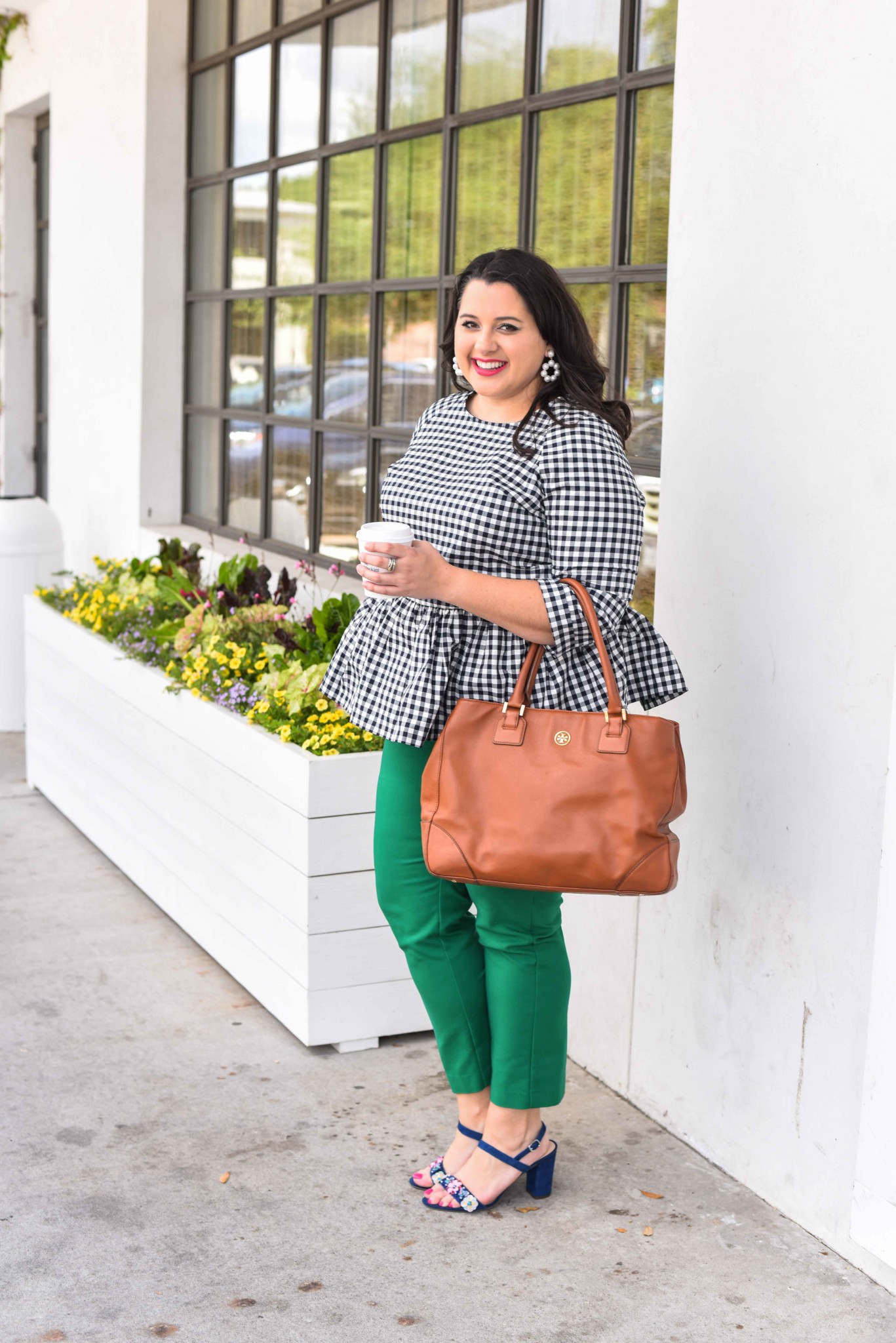 Traveling can be stressful, especially when your flight is delayed or even worse, cancelled. In today’s blog post, I’m sharing a few travel delay tips that will help you make the best of the situation. I’m also talking about wearing a quintessential preppy item, a gingham peplum top. Emily Bastedo from the curvy style blog, Something Gold, Something Blue, is sharing how she is styling this gorgeous spring top perfect for both work and happy hour. Plus size, curvy, fashion, style, travel tips. - Travel Delays by popular Houston travel blogger Something Blue, Something Gold