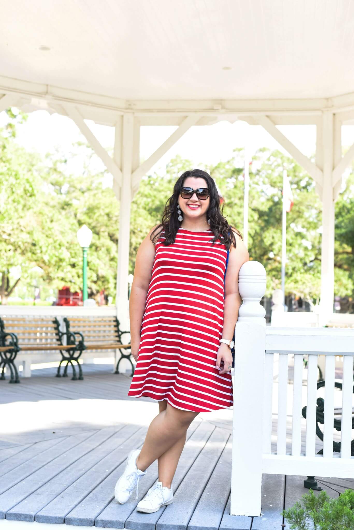 Looking for the perfect 4th of July outfit? Emily Bastedo from the curvy style blog, Something Gold, Something Blue is sharing a light and breezy red and white striped dress paired a blue accent bag. Summer style, Sneakers with dresses, Curvy style