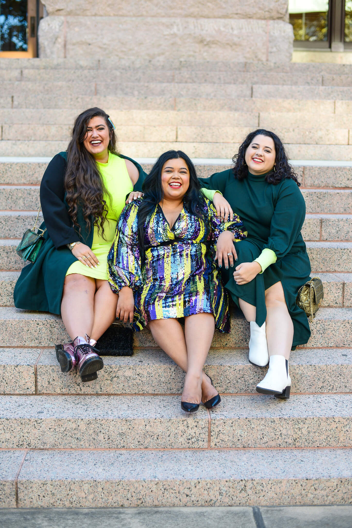 Plus size group of women wearing Eloquii emerald outfits 