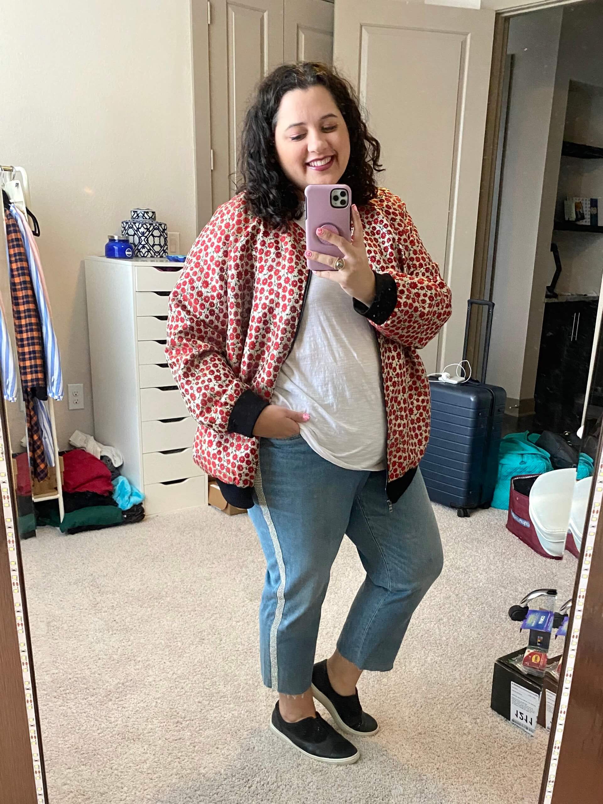 The perfect travel day outfit - plus size girlfriend jeans, a white tee, statement jacket and comfortable sneakers 